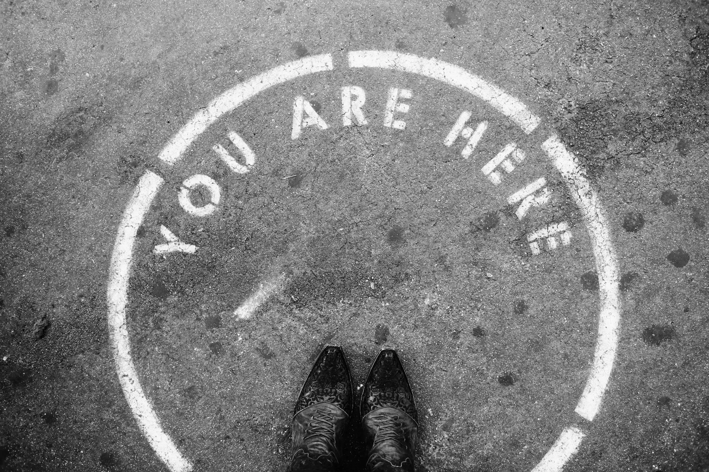 Person standing on"You are here" circle