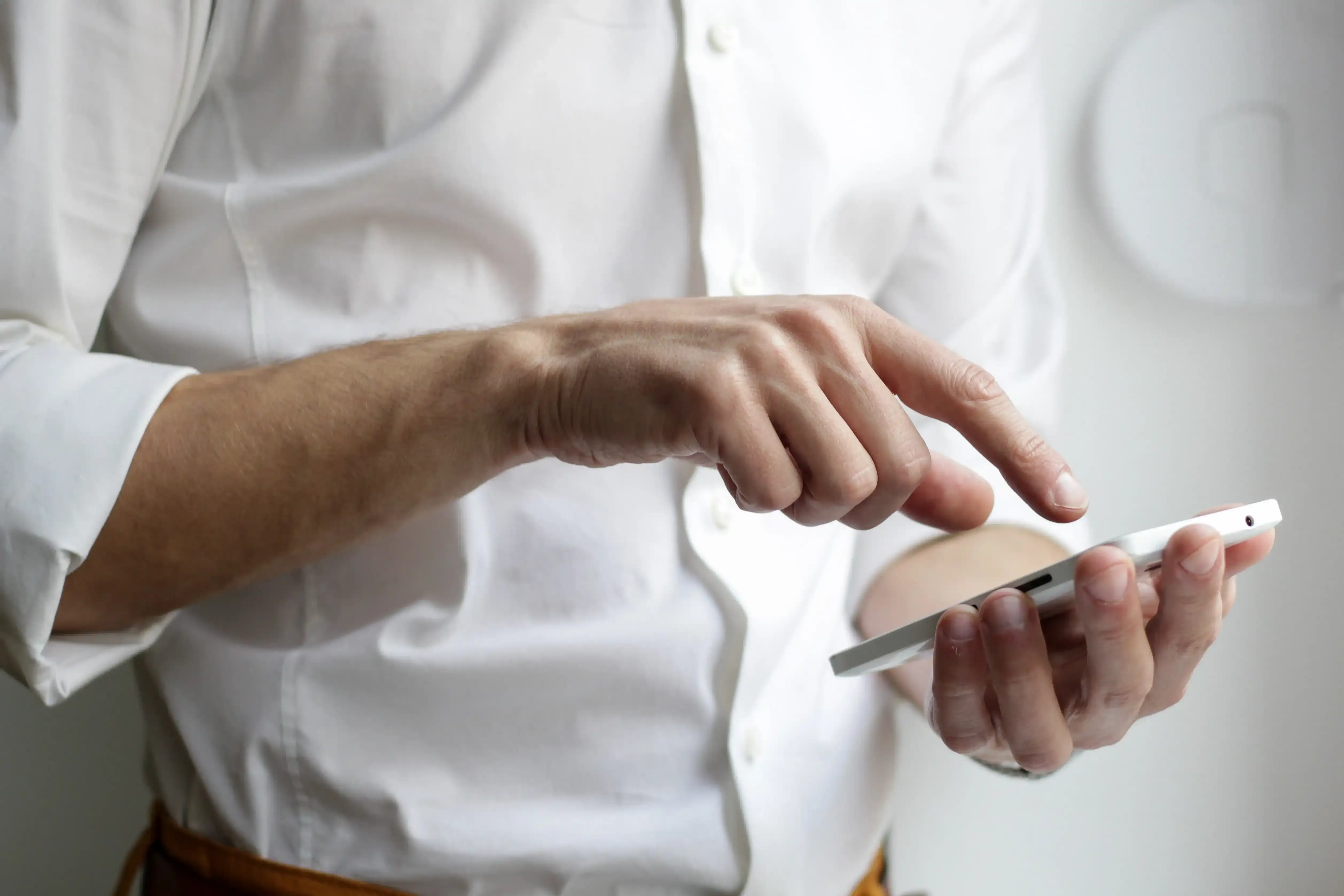 man tapping mobile phone